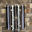 Load image into Gallery viewer, beach vibes macramé wall hanging on brick wall
